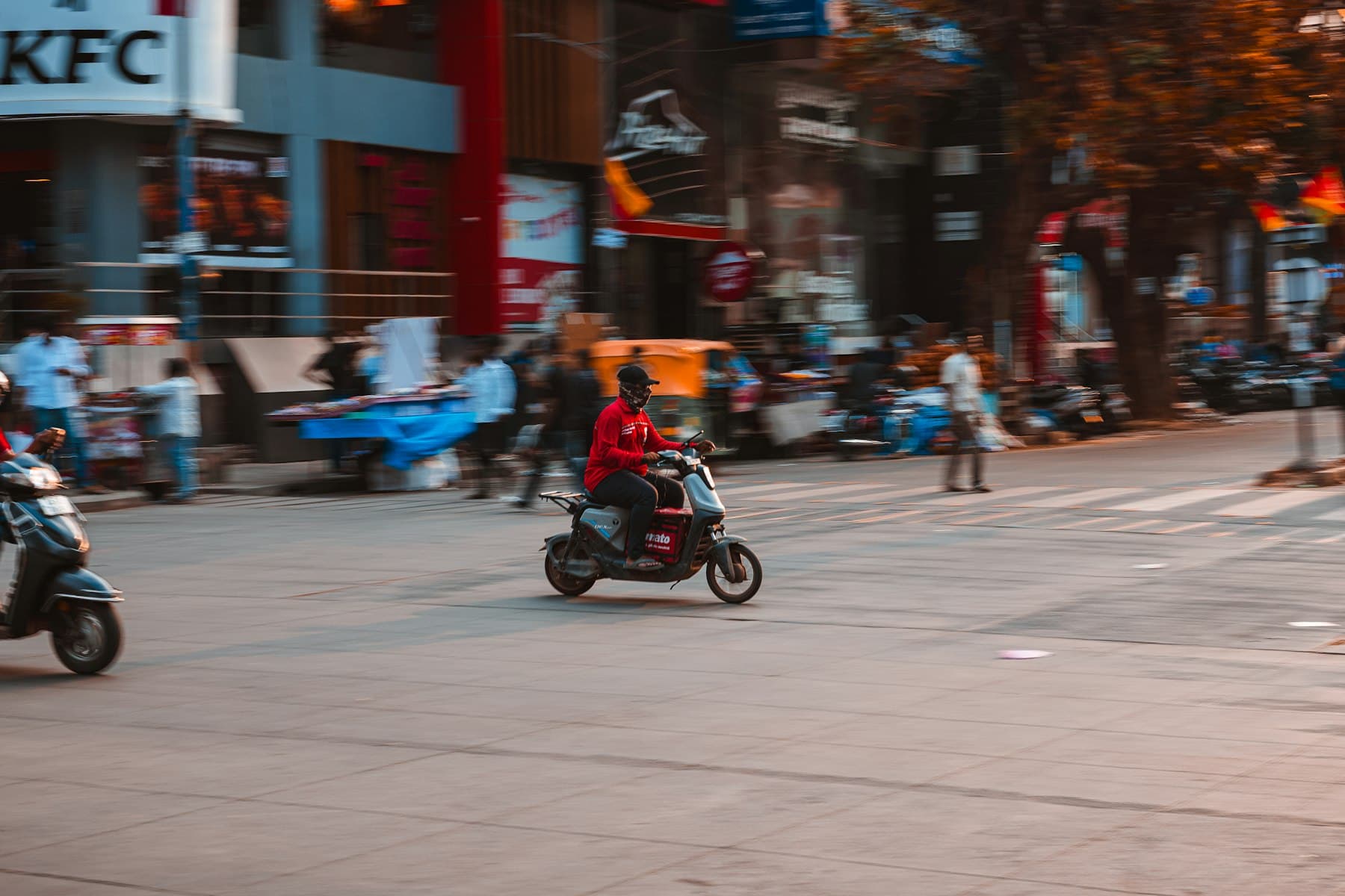Delivery rider on a scooter on a city street